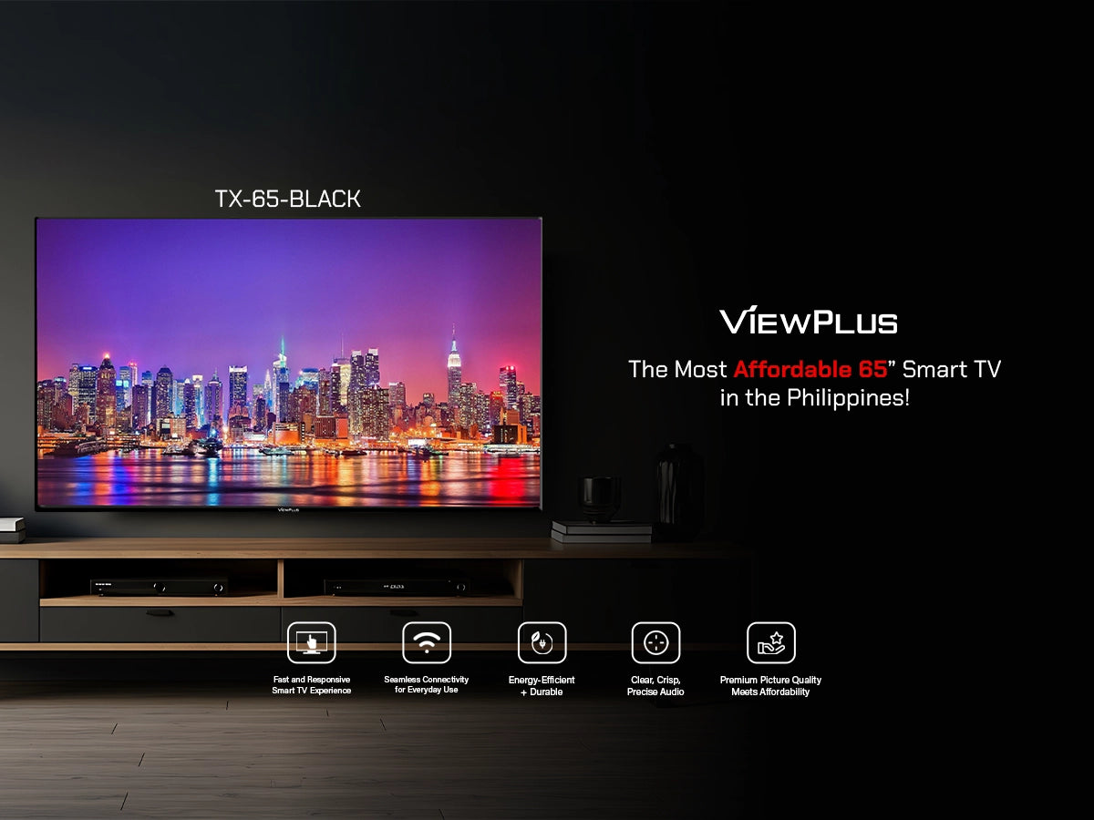 Viewplus TX-65-BLACK 65-inch Smart TV showing a vibrant illuminated city skyline at night, mounted in a modern living room setting.
